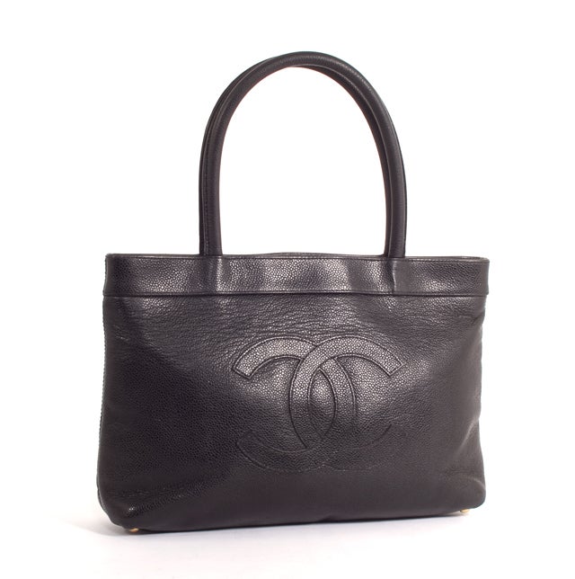 This is an authentic CHANEL Caviar Quilted Executive Cerf Shopper Tote. This sophisticated bag is done in a solid black Caviar leather; the most durable of all Chanel leathers, perfect for everyday.  It has dual rolled handles and a stitched CC logo