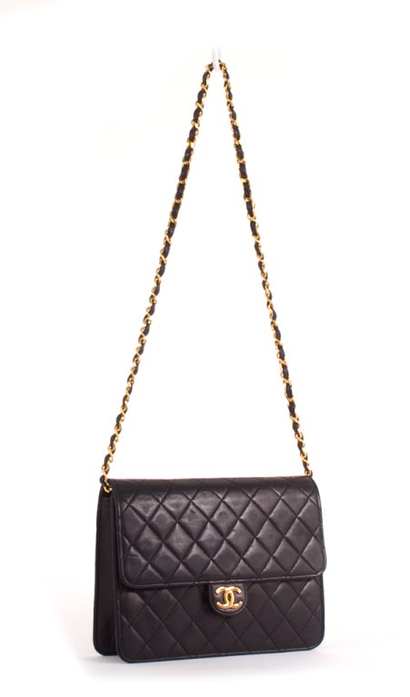 This is an authentic Chanel Quilted Black Lambskin Medium Single Flap Bag. Done in the most luxurious black lambskin leather, this bag features a classic chain and leather entwined chain strap and a signature Chanel logo front interlocking 