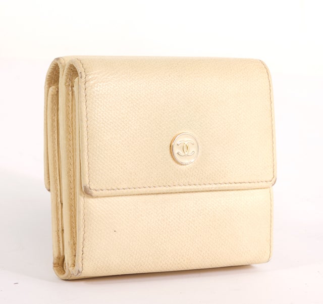 This is an authentic CHANEL Ivory French Purse Wallet. It is done luxurious ivory caviar leather with elegant gold hardware. It features two compartments on either side of the wallet. One compartment opens up to reveal two gussetted pockets. The