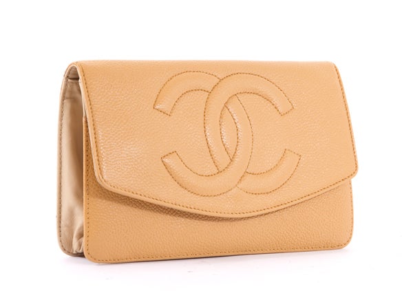 This is an authentic CHANEL Camel Beige Caviar Leather Wallet Clutch. It is done in supple caviar leather with elegant gold hardware. It features a flap top with snap closure, exterior coin zipper pocket, and a large CC Chanel logo stitched on the