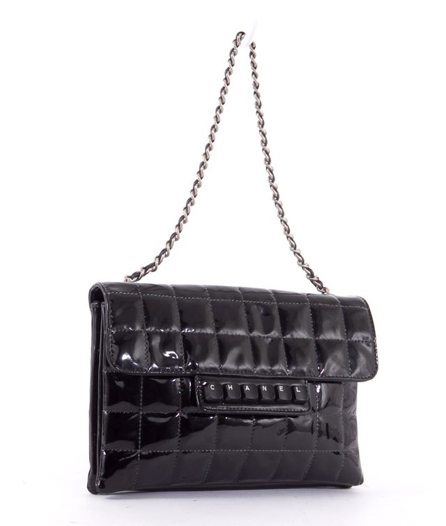 This is an authentic CHANEL Black Patent Leather KEYS BUTTONS Retro Flap Mini Bag. This small beauty is done in stunning quilted patent leather and features computer key button accents, a single leather chain link closure, and a flap with snap