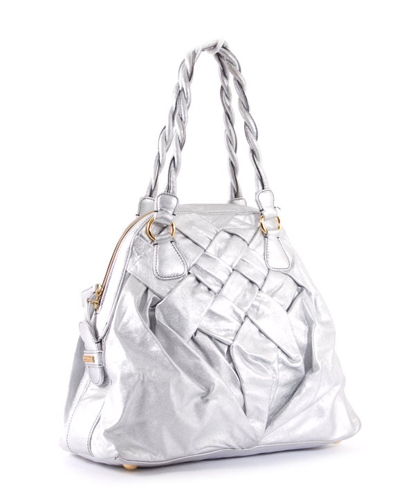 This is an authentic VALENTINO GARAVANI Metallic Nappa Leather Couture Braided Tote.  This brilliant bag is done in luxurious silver metallic woven calfskin leather and is contrasted with gold-Toned hardware and braided handles.  The bag features a