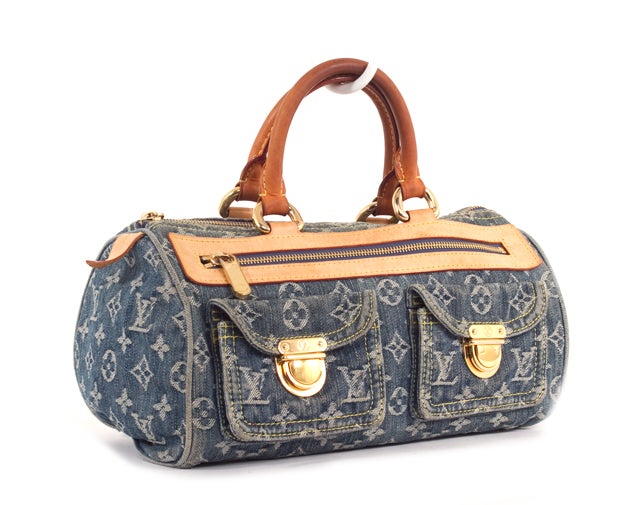 This is an authentic LOUIS VUITTON Blue Denim Neo Speedy Bag. It is done in limited edition blue monogram denim with vachetta leather trim and golden brass hardware. It features two rolled leather handles, a top zipper closure, an exterior zipper