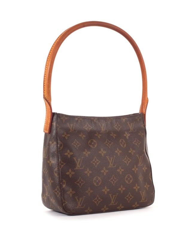 This is an authentic Louis Vuitton Monogram Canvas Looping MM bag. It is done in the signature Louis Vuitton monogram coated canvas with vachetta leather trim, and beautiful gold-Toned hardware. An elegant and slim-line shape which fits neatly under