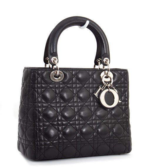 This is an authentic Christian Dior Classic Lady Dior Black Cannage Quilted Bag. It is done in signature Christian Dior Cannage style in black leather with elegant silver hardware. The bag features two comfortable handles, a zip top closure, a flat