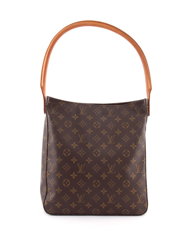 This is an authentic Louis Vuitton Looping GM bag. It is done in the  signature Louis Vuitton monogram coated canvas with vachetta leather trim, and beautiful gold-toned hardware. An elegant and slim-line shape  which fits neatly under the arm, this