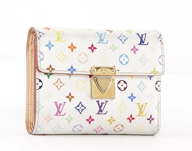 This authentic Louis Vuitton Koala Wallet is done in gorgeous white multicolor monogram canvas  with a small gold push lock. The wallet has a zipper closure slot pocket on the back for change and a flap with a gorgeous sliding lock closure on the