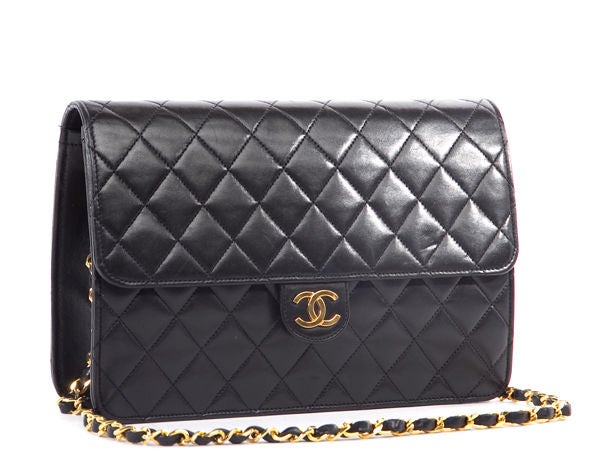 This is an authentic Chanel Quilted Black Lambskin Medium Flap Bag. Done in the most luxurious black lambskin leather, this bag features a classic chain link long chain strap and a front CC turnlock shoulder, both in fabulous golden hardware. The