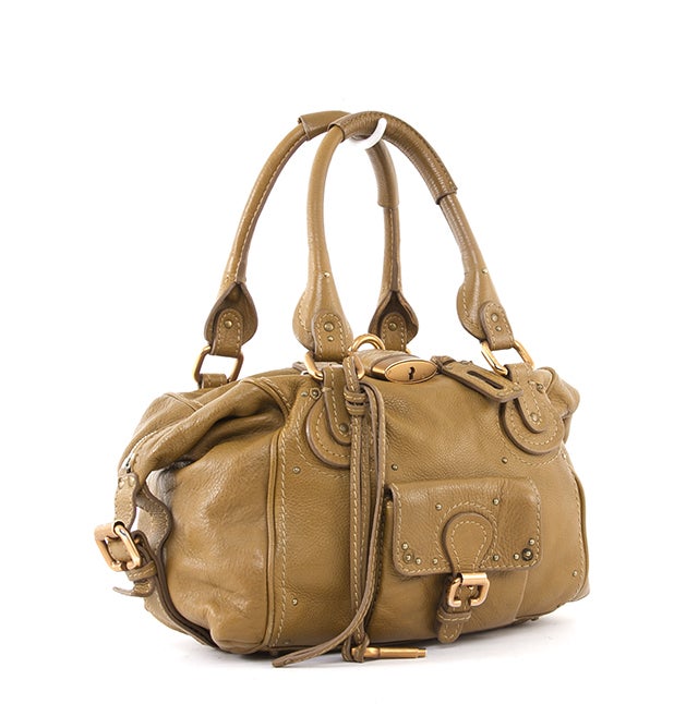 This is an authentic CHLOE Leather Front Pocket Paddington Satchel Bag. Done in a fantastic olive tone, this is a great handbag for everyday. The bag features intense detailing such as chunky hardware, contrasted stitching, while also including