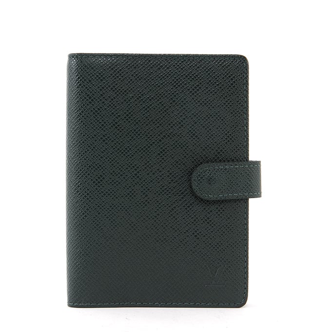 This is an authentic Louis Vuitton Agenda. Done in Louis Vuitton's taiga leather, this agenda gives a classic, elegant feel to organizing your daily life. It features a fabulous coordinating leather interior with card slots, flat pockets, and six