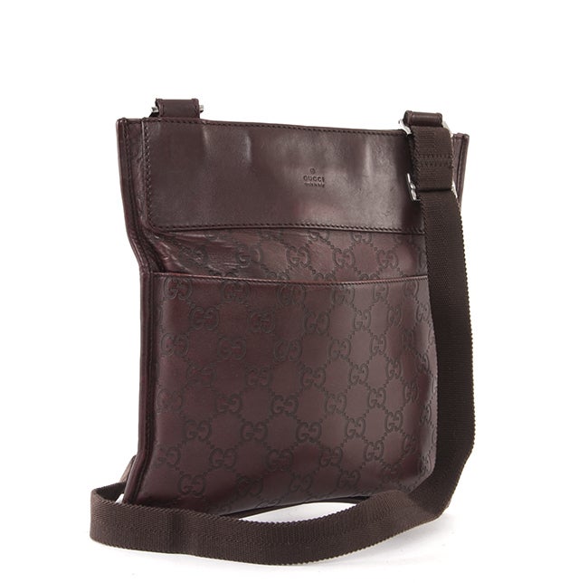 This is an authentic GUCCI Monogram Guccissimma Leather Flat Messenger Bag. It is done in smooth brown leather GG Guccissimma monogram with leather trim. This bag features a flat structure with two exterior flat pockets, an adjustable crossbody