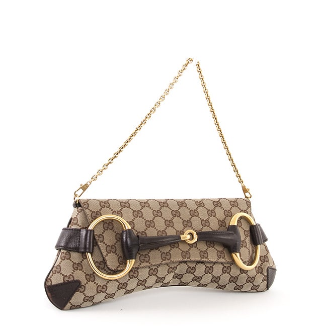 This is a classic Gucci Monogram Horsebit Flap Bag. Done in Gucci GG monogram fabric, with brown leather trim, this bag features fantastic gold-toned hardware and accents. The bag has a flap over top and the front tucks in neatly to the Horsebit