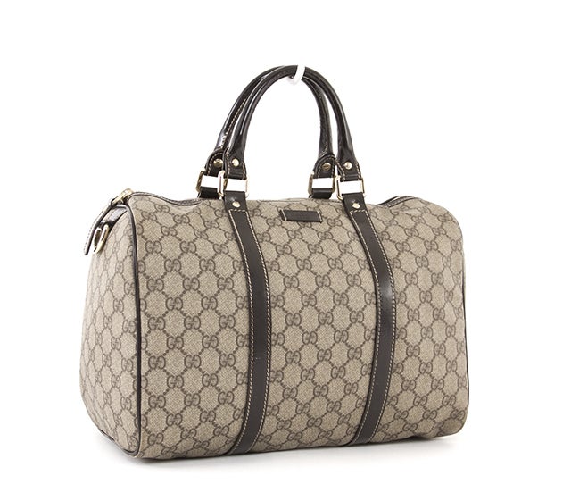 This is an authentic Gucci Bag. It is done in gorgeous canvas with Gucci monogram web print and dark brown leather trim. It features two comfortable rolled leather handles and a zipper top closure. The spacious interior is lined in chocolate brown