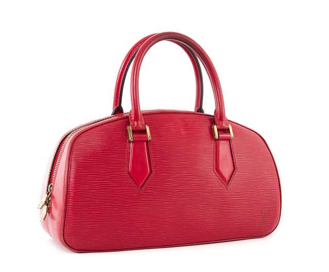 This is an authentic Louis Vuitton Red Epi Jasmin Bag. It is done in durable Louis Vuitton epi leather with lovely gold tone hardware and smooth red leather trim. It features two comfortable rolled leather handles, and a top double zipper closure.
