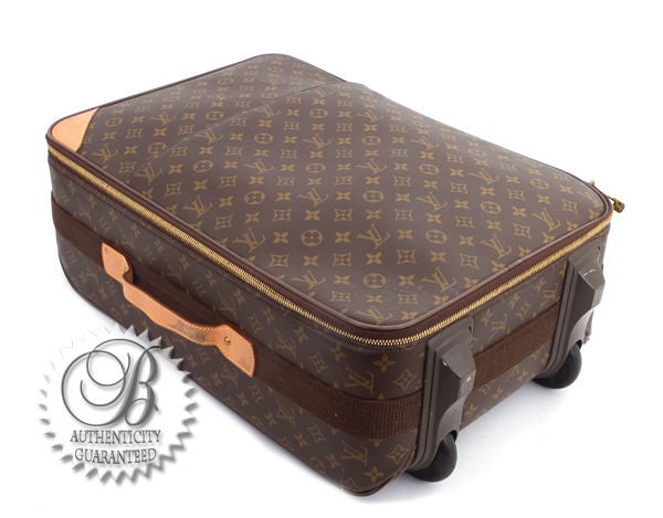 This is an authentic Louis Vuitton Pegase rolling luggage suitcase, a perfect travel accessory for your next trip. Done in classic Louis Vuitton monogram coated canvas with leather trim, this bag features Classic LV monogram canvas print with lovely