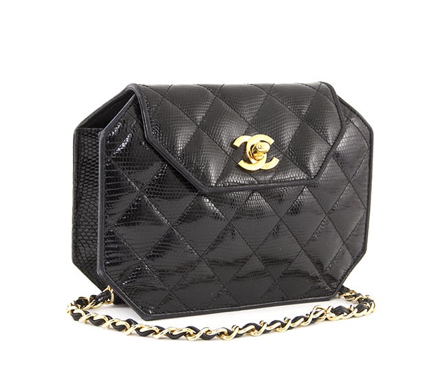 This is an authentic Chanel bag. This beauty is done in shiny black leather with an 8-sided structure. It features gold-toned hardware, a leather-chain link shoulder strap, and a flap with CC turnlock closure. The small interior is done in