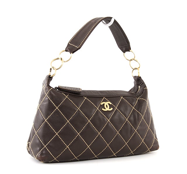 This is a fabulous and absolutely guaranteed authentic Chanel Surpique Bag. Done in signature Chanel brown lambskin leather with CC logo and contrast Surpique stitch quilted detailing, this elegant classic is sure to add a touch of sophistication to
