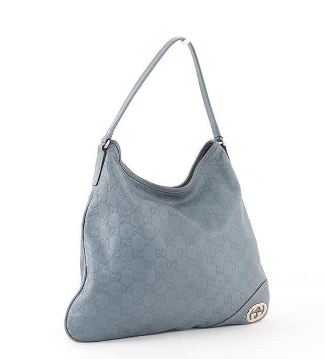 This is an authentic GUCCI Guccissima GG Hobo Britt Bag. It is done in blue signature Gucci Guccissima monogram canvas with silver-toned hardware and a Gucci hardware accent at its corner. It features a flat structure and a single flat leather