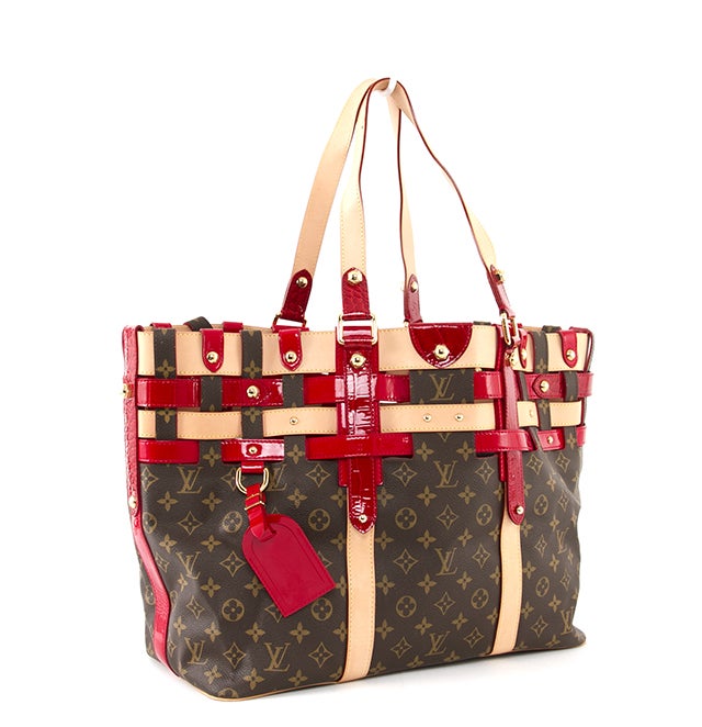This is an authentic Louis Vuitton tote. It is done in traditional LV monogram canvas with unique red patent leather and vachetta leather interwoven trimming. It features gold-toned hardware and accents, two flat handles, and an open interior.