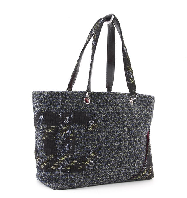 This is an authentic CHANEL CAMBON Shopping Bag. It is done in blue, green, and black tweed with a signature Chanel interlocking c logo at the side. It features two flat carrying handles and a flat bottom. It also features an exterior flat pocket