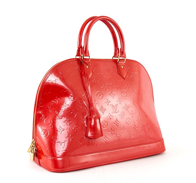 This is an authentic Louis Vuitton Vernis Alma MM bag. It is done in glossy Vernis patent leather with embossed monogram Louis Vuitton logo throughout the body of the bag accented by elegant golden hardware. It features a flat, structured bottom,