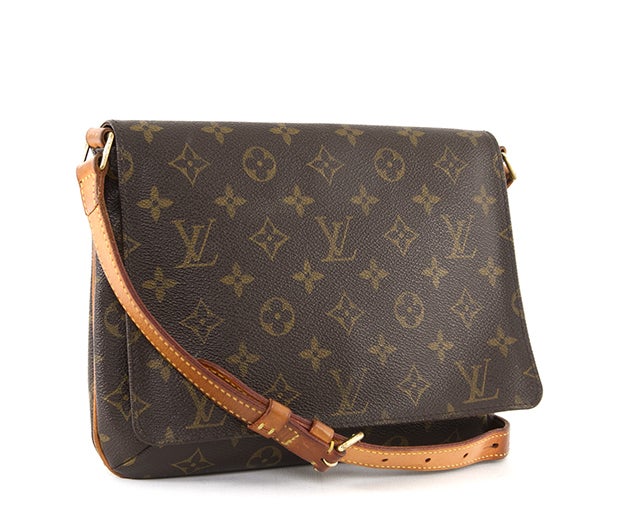 This is a guaranteed authentic Louis Vuitton Monogram Canvas Musette Tango Bag. It is made of the traditional LV monogram canvas with natural leather trim and has a single adjustable flat leather strap. It has a flap top with magnetic snap closure,