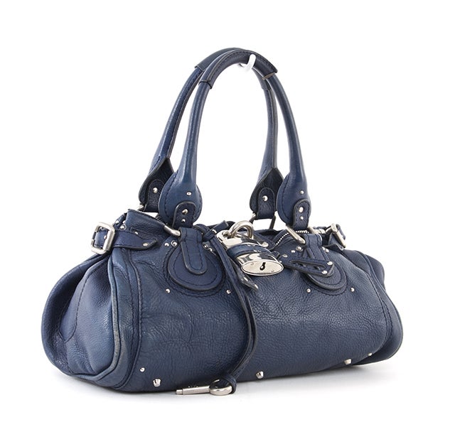 This is an authentic CHLOE Blue Leather Paddington Bag. Done in a fantastic blue tone, this bag features intense detailing such as chunky hardware, contrasted stitching and belting as well as two-rolled leather handles. At the front of the bag you