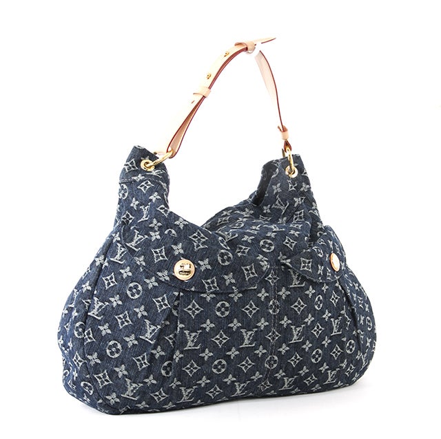 This is an authentic Louis Vuitton Monogram Denim Daily GM bag. Done in 