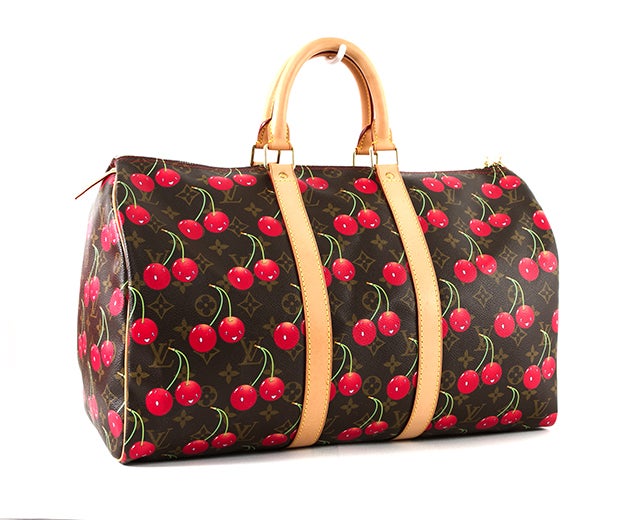 This is an authentic Louis Vuitton Monogram Cerises Keepall. Created for the Spring-Summer 2005 collection as a collaboration between Marc Jacobs and Japanese artist Takashi Murakami, this bag is playful and functional. The exterior is monogram