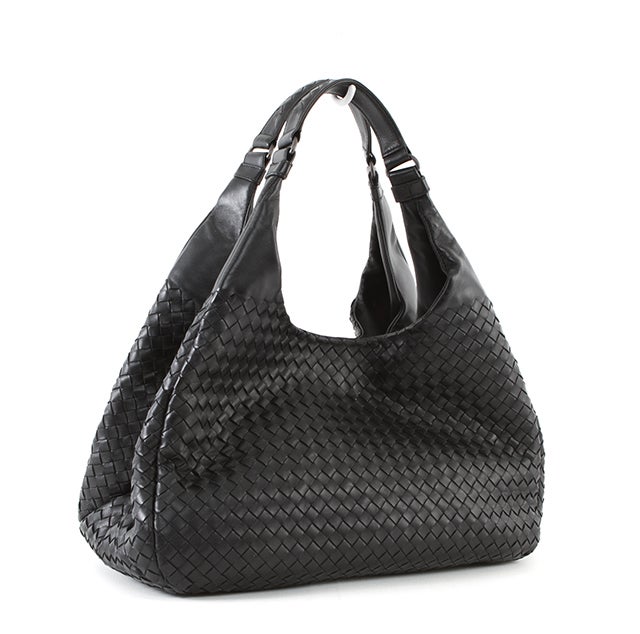 This is an authentic Bottega bag! Like all gorgeous bags by this design house, the Campana was meticulously constructed from intrecciato nappa leather and is simply chic. The bag is roomy with its wide bottom, but maintains a delicate appeal, making