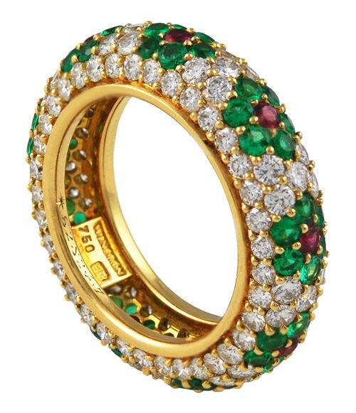 Gorgeous Winston flower ring featuring vibrant emeralds with a ruby center, flanked with high quality diamonds, crafted in 18kt gold, Stamped Winston.<br />
Emeralds-54 weighing 1.50 cts<br />
Rubies-9 weighing .50 cts<br />
Diamonds-117 weighing
