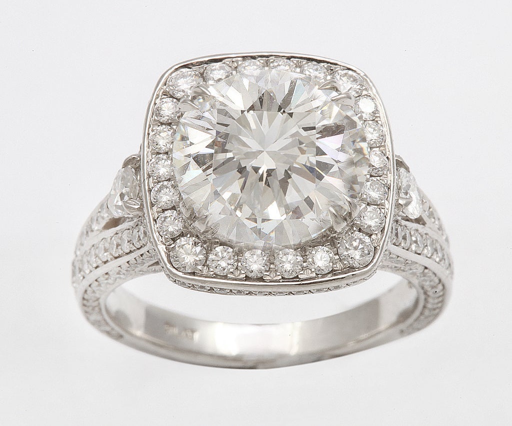 Gorgeous GIA Round Brilliant diamond ring, center stone weighing 4.04 CTS, Color: I, Clarity: VS1, surrounded by a diamond halo and numerous diamonds along the mounting, platinum. 
Mounting:
Pears: 0.21 CTS
Round: 260 diamonds- 1.65 ct