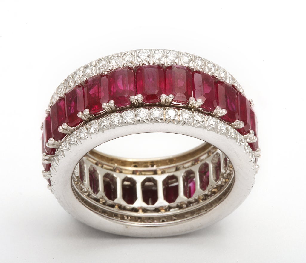 Platinum & 18k three row band featuring 24 rubies weighing 7.51 carats and 90 round diamonds weighing 0.85 carats.