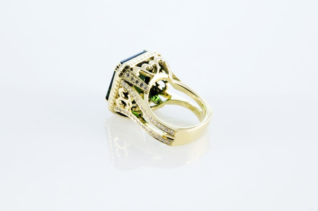 16.4 carat green Tourmaline set with 1.22 carats of F/G VS Diamonds and 20.2 grams of 18K Yellow Gold.