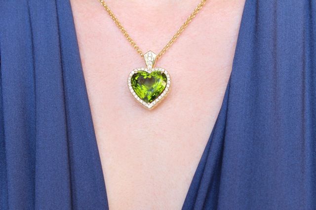 24 carat heart-shaped Pakistani Peridot surrounded by 0.64 carats of F/G VS Diamonds and set in 14 grams of 18K Yellow Gold, hung on a 16 inch 18K Yellow Gold Rolo Chain.