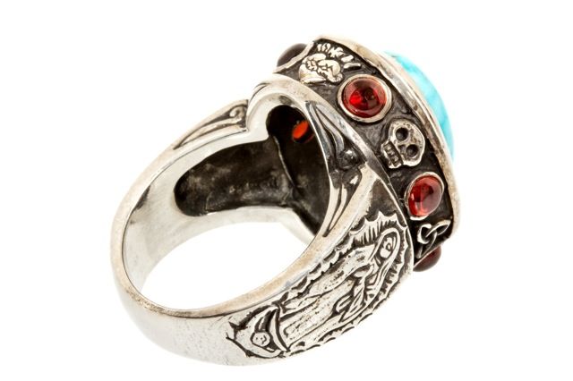 Turquoise cabochon (10x14mm oval) set with 2.7 carats of Garnets and .925 Sterling Silver.  The “Alleluia” ring features hand carved, intricate religious details, depicting Christian imagery.  Around the side bezel, the following hand carved images
