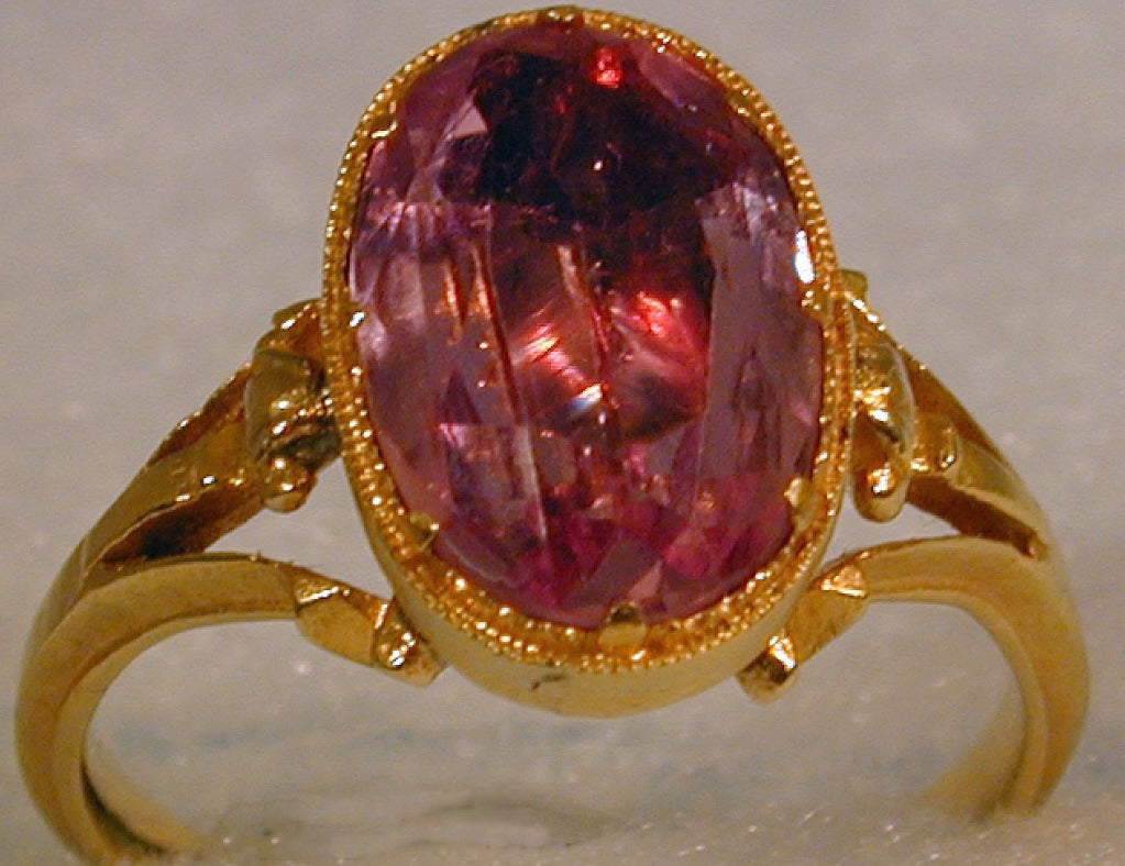 Georgian pink topaz ring set in an 18K gold delicately articulated mounting. This lovely ring can be worn day or night. The ring is size 4 1/2  and can be sized to fit.