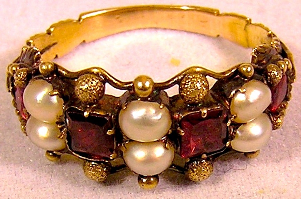 Lovely 15K gold, natural pearl and square cut almandine garnet ring in an elaborate bead setting with a foliate band.
