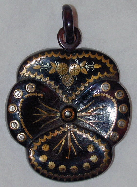 Lovely pique pansy pendant can be worn with a gold or silver chain. Pique, tortoiseshell inlaid with gold and silver, was developed in France and became popular in England in the late 19th century.