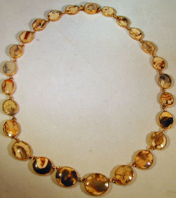 Georgian moss agate jewelry was popular for the variations of the designs in the stones. Inclusions of other minerals in the transparent stones can appear as cloud or foliate formations. This unusual necklace of graduated oval stones is a wonderful