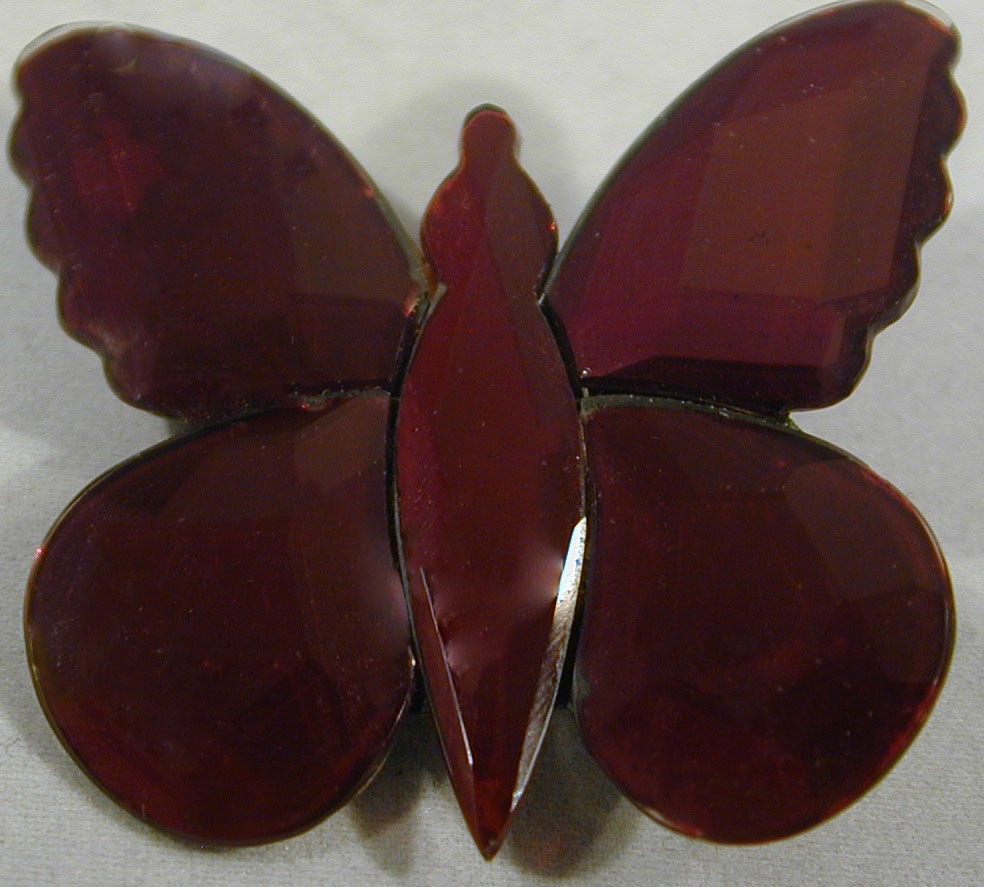Shimmering mirrored red glass butterfly reflects the world around it delighting the eye.  Made at the Vauxhall Glass Works in London from the 18th century through the middle of the nineteenth, it was sold at the Vauxhall Pleasure Gardens nearby.