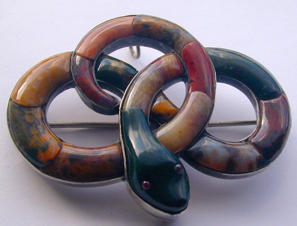 Striking snake pin of various types of agate set in silver. This jewelry became popular when Queen Victoria vacationed at Balmoral Castle and embraced all things Scottish.