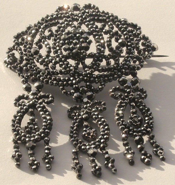 Cette fabuleuse broche en acier taillé avec trois gouttes en forme de lyre brillera de jour comme de nuit. On dit que les bijoux en acier coupé ont vu le jour à Woodstock, en Angleterre, où ils ont évolué à partir de l'artisanat de la construction