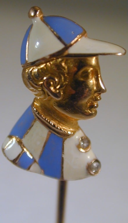 18K gold and blue and white enameling enhance this stickpin of a handsome jockey ready for the race. The pin is in 15K  for strength.