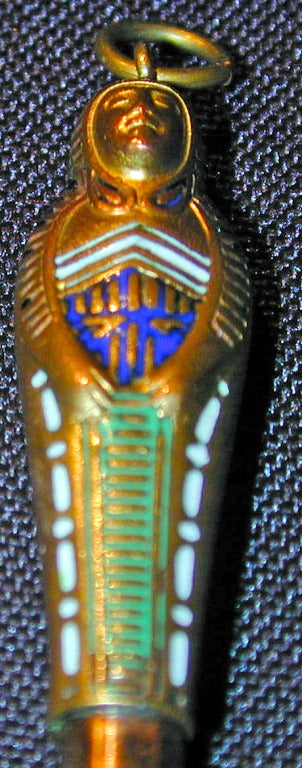 Wonderful to wear as a pendant this retractable pencil slides into an enameled gilded mummy. In the 1870s-1880s, the  Egyptian Revival styles were in vogue as archaeological digs  discovered ancient tombs that brought to light rare finds. Their