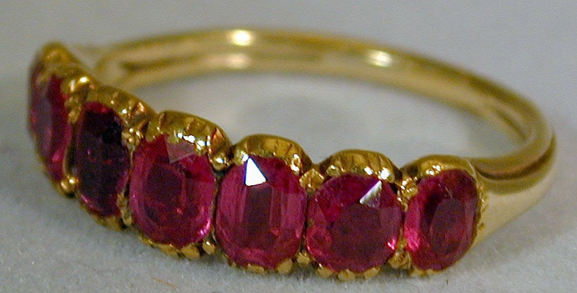 Georgian period seven stone Burma ruby ring set in 18K yellow gold will look wonderful worn on its own or stacked with other bands. The total weight of the stones is 2.5 carats and the ring size is a 7.
