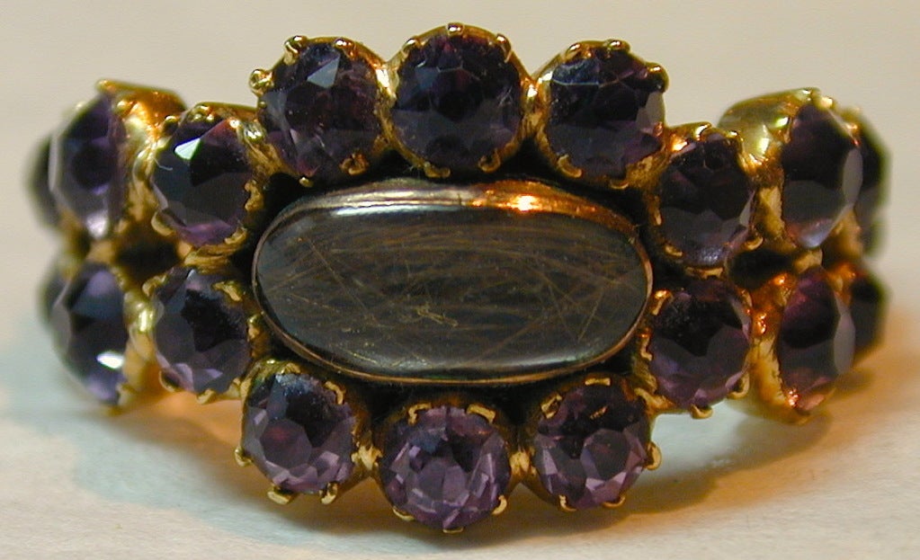 Georgian amethyst cluster ring set with a lock of hair in 15K gold was memorialized in the early 1800's. The inscription reads 