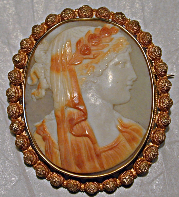 Georgian shell cameo of a young women set in an 18K gold cannettile bezel.  The classical motif of the cameo suggests it was acquired by a traveler on the Grand Tour of Europe while in Italy. The brooch measures 1 7/8