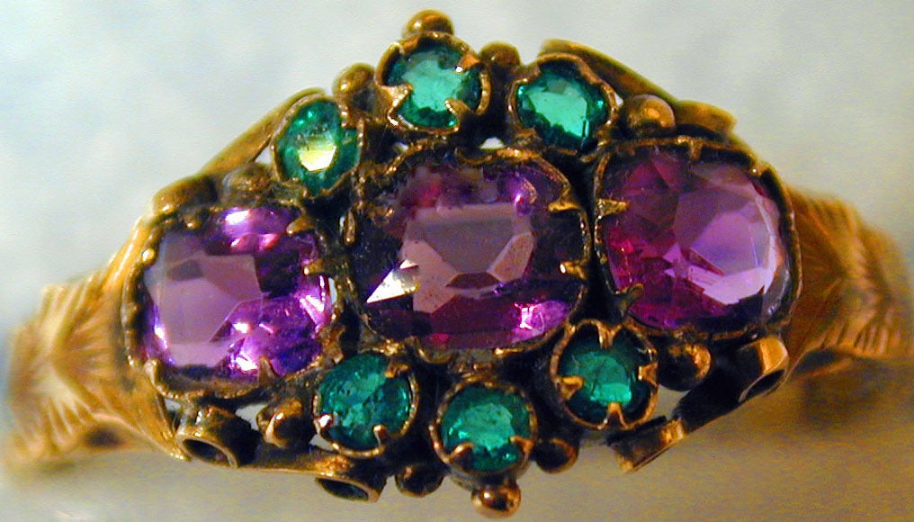 Lovely Victorian multistone cluster ring set with amethysts and emeralds in an elaborate 12K yellow gold setting. The ring has hallmarks for Birmingham, England, 1870, is a size 8 and measures 1/4