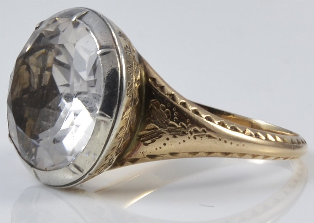 Dazzling Georgian paste ring in an intricately engraved 15K gold and silver setting. Large solitaire rings such as this one are very rare. The ring is a size 6 1/2. The stone measures 1/2